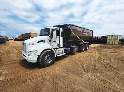 Sunnyside Roll-Offs truck and roll-off container ready for a dumpster rental Denver delivery