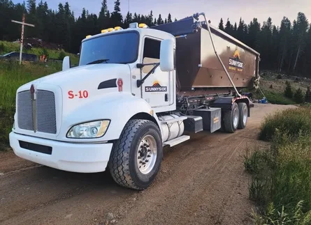 Sunnyside Roll-Offs truck used for roofing dumpster rental in Colorado